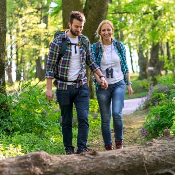 couple hiking while enjoying a Fall Colour Escape