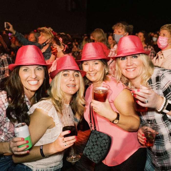 Four friends dressed in pink at a concert