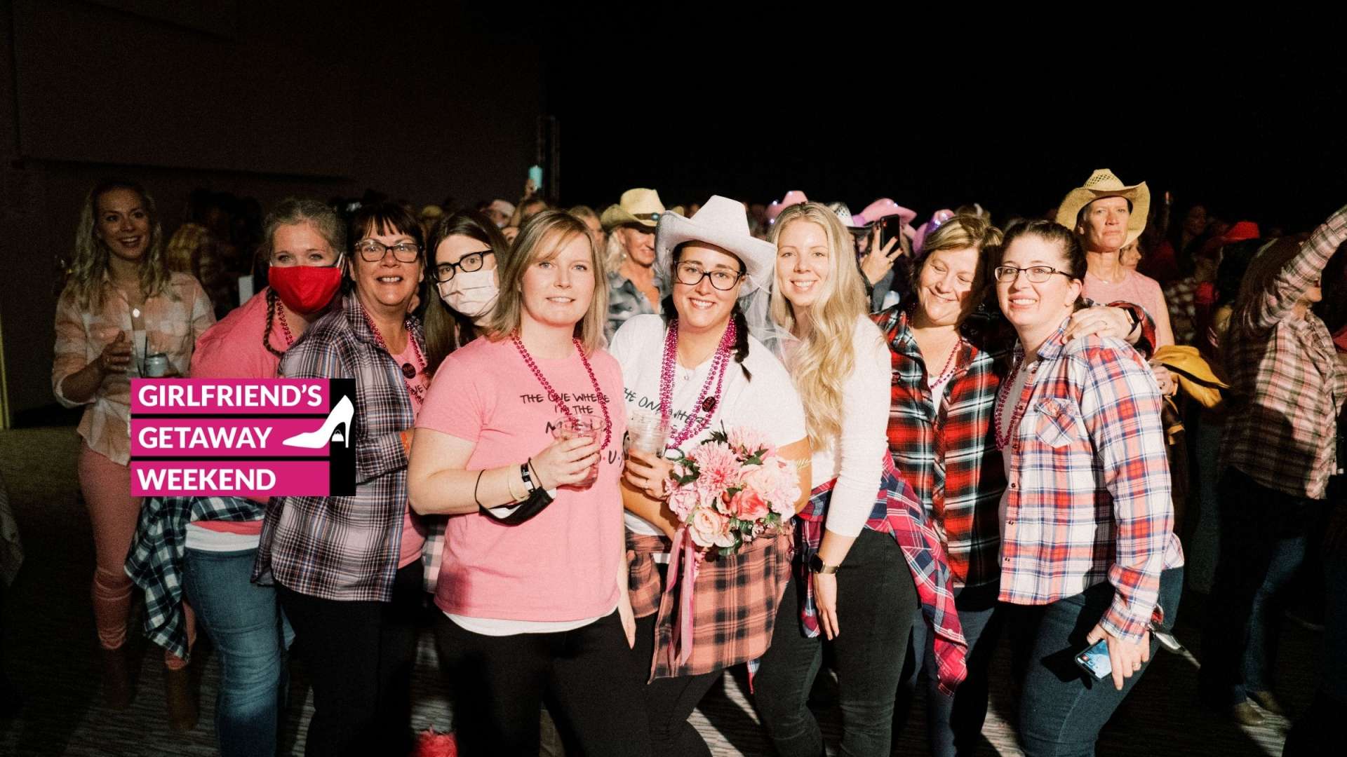 a group of friends dressed in pink at a concert