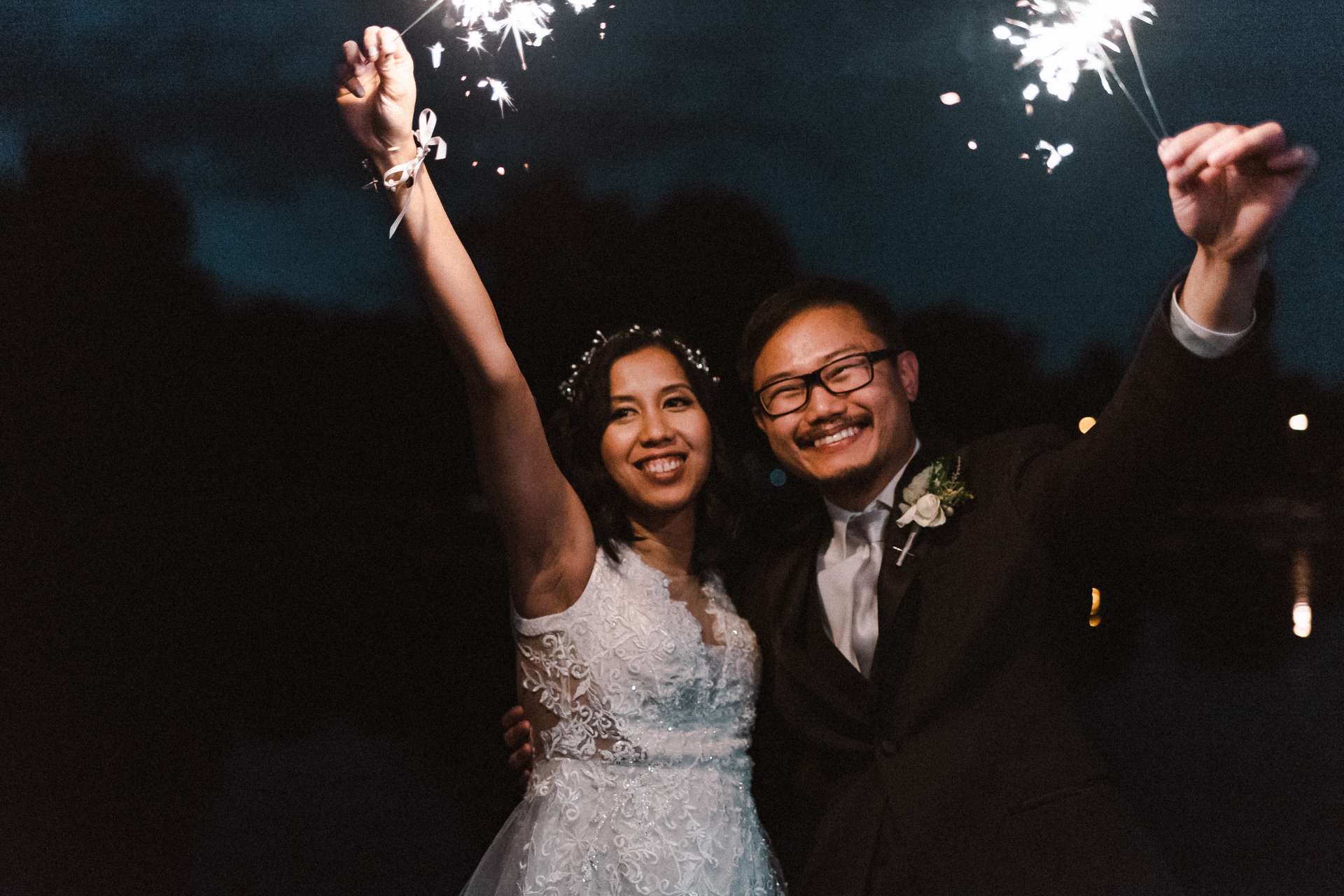 Wedding couple holding up sparklers